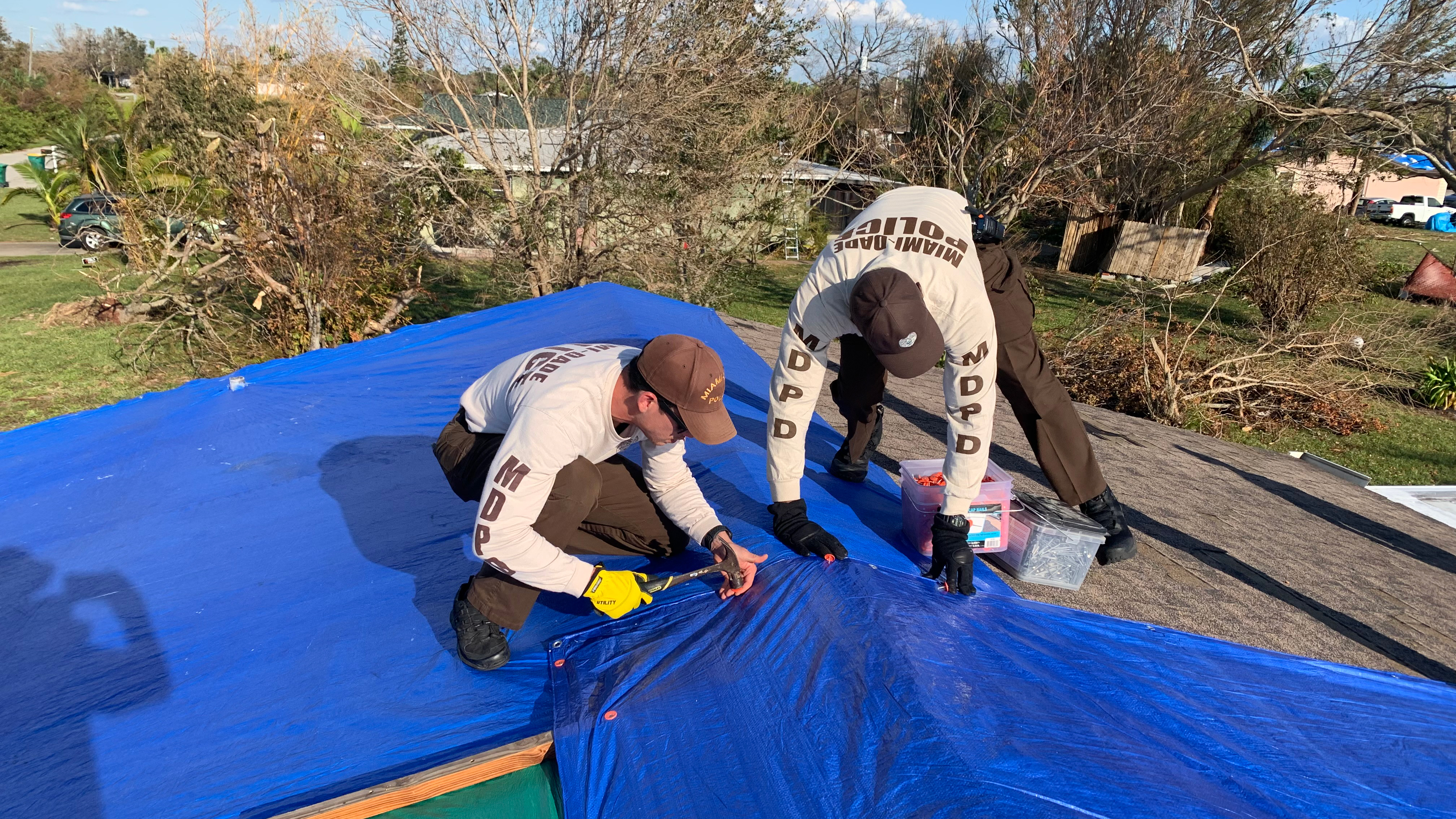 Two Police officers repairing a roof