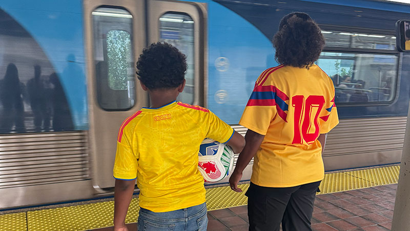 mother and son waiting for metrorail train