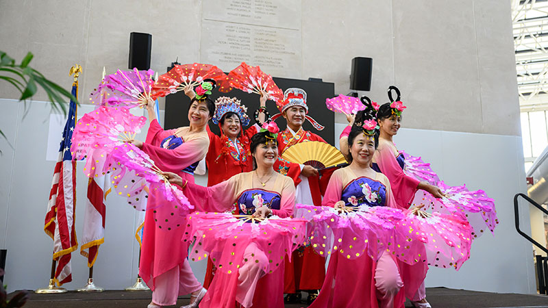 A group of Asian men and women on stage