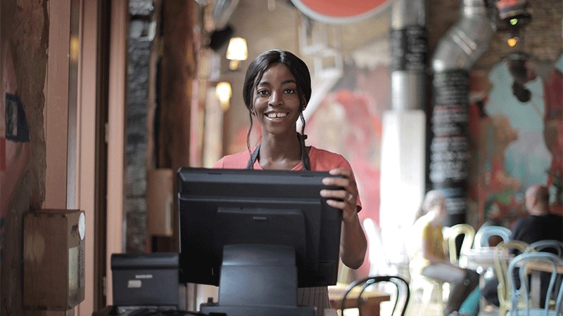 Girl standing in front of cashier.