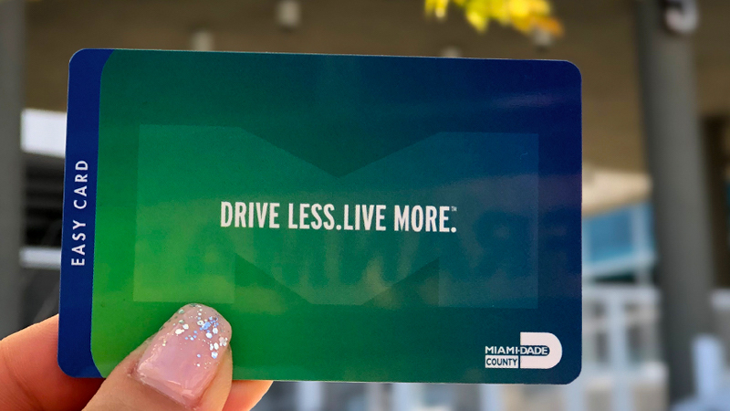 hand with a glittery polished nail holding an EASY Card