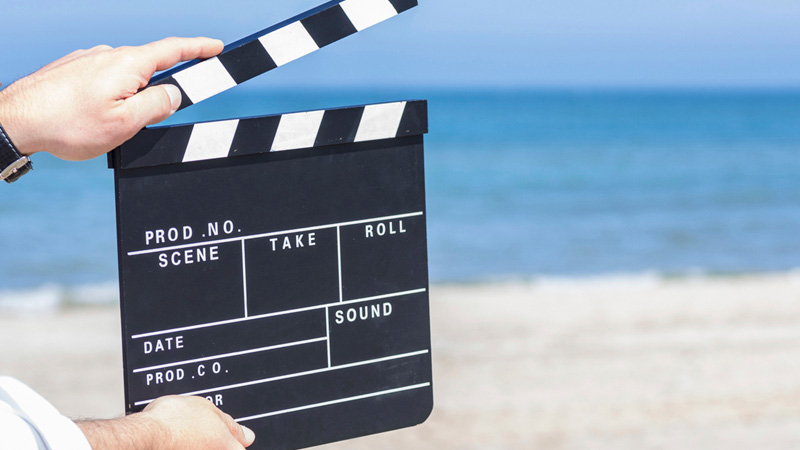 Movie clapboard on a beach