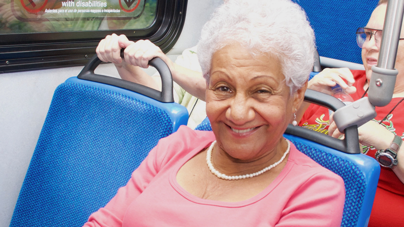Elderly woman riding Metrobus.