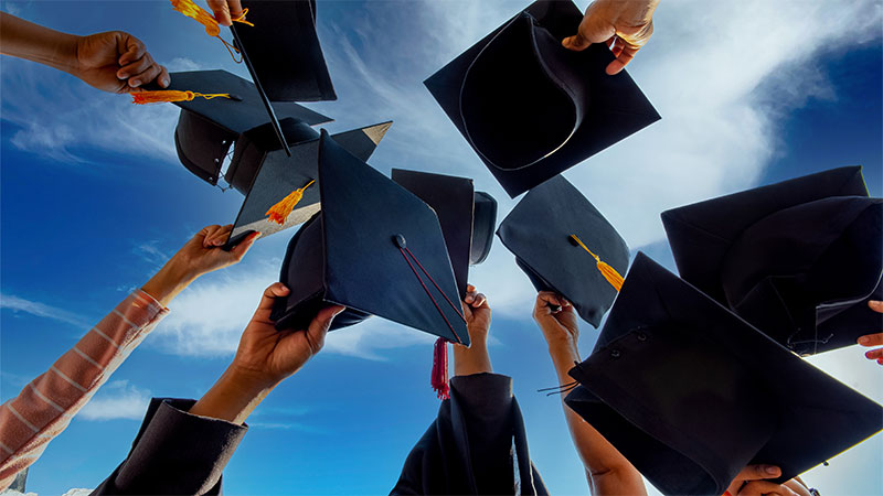 Celebration with graduation caps thrown in the air