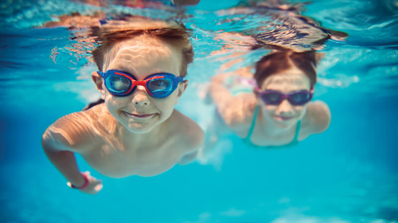 Two children swimming in pool.