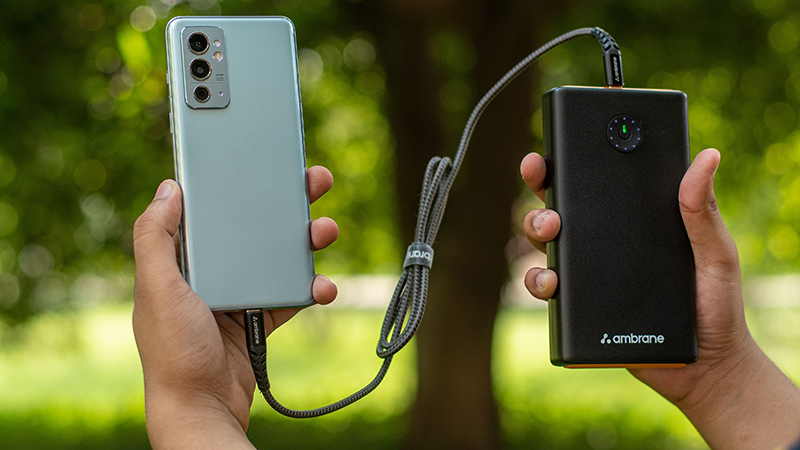 Mobile phone connected with a cord to a battery pack