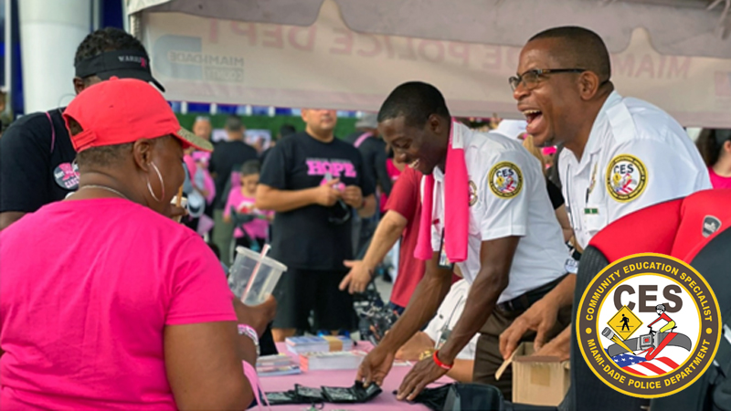 community education specialists at an event attending to people at their booth