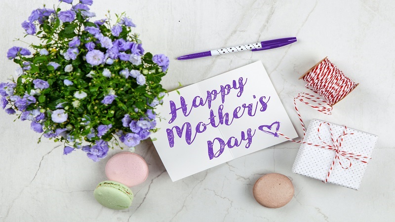 Image of Mother's Day greeting, flowers and gift