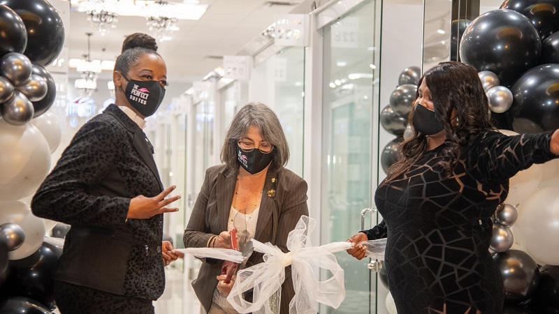 Image of the Mayor's ribbon cutting event with a small business.