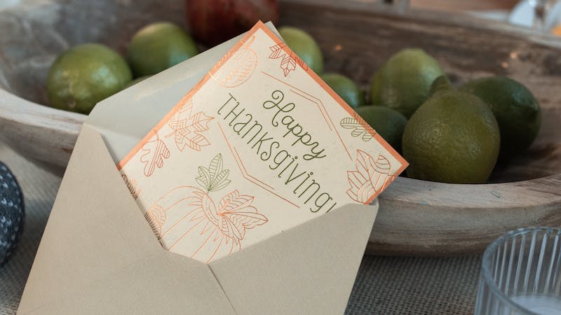 card on table that reads happy thanksgiving