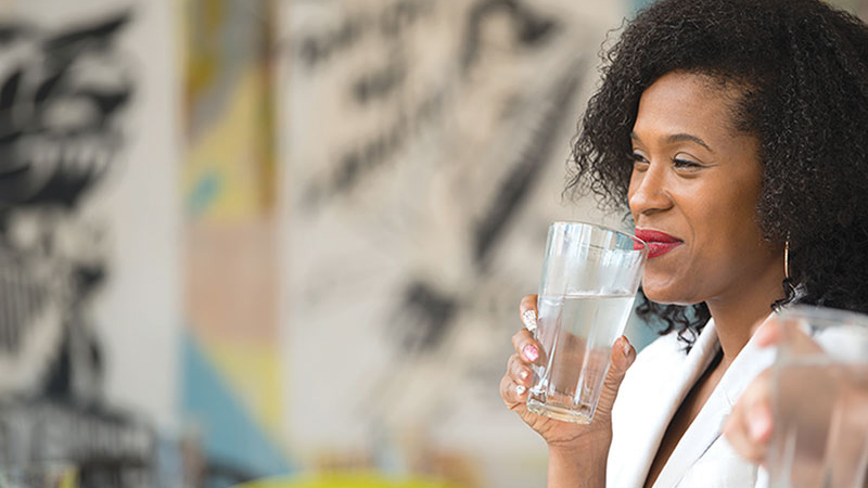 woman drinking water from a glass