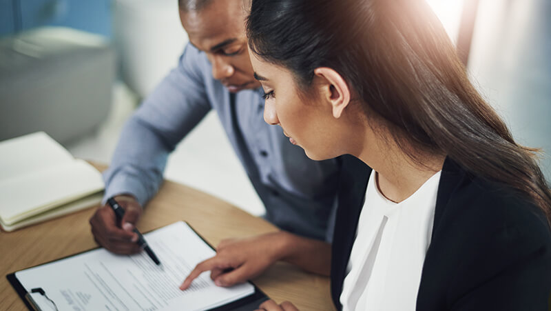 Two people going over paperwork.