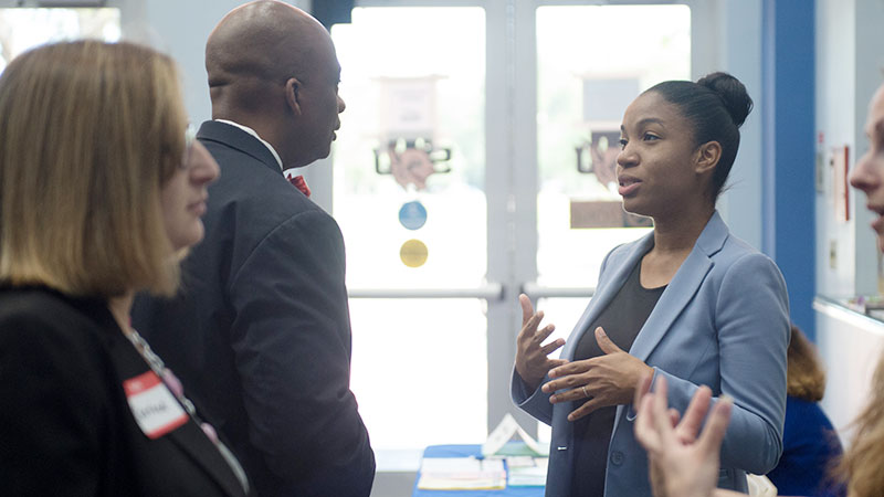 People have a discussion at a meeting.