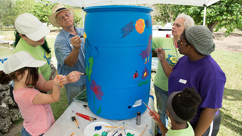 Family around a rain water barrel