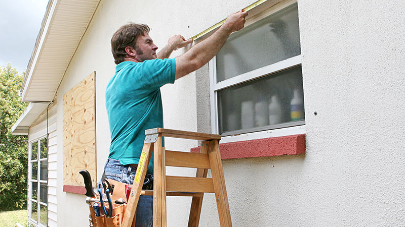 Man boarding up windows