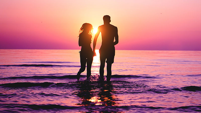 couple in the ocean at sunset