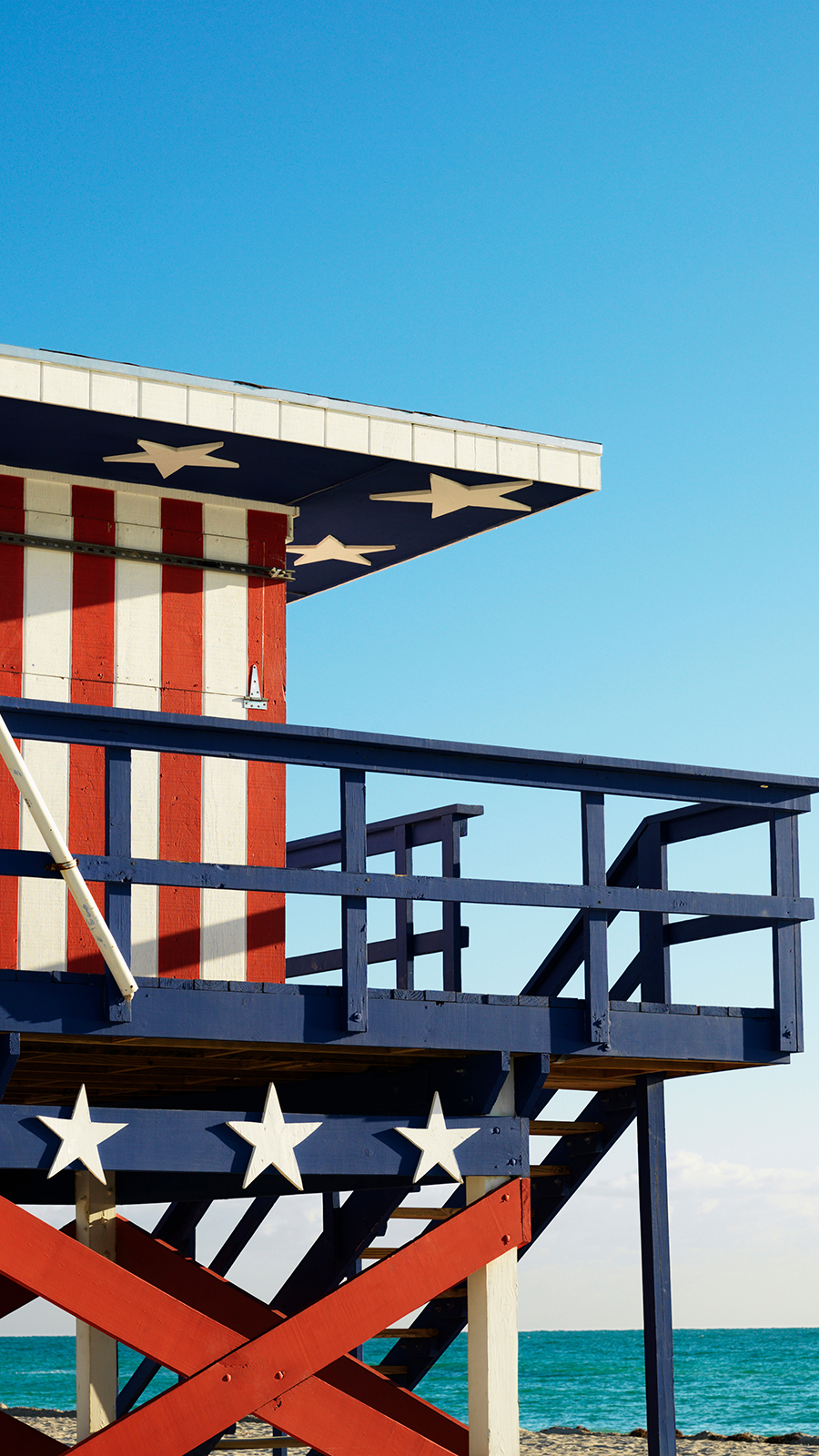 lifeguard station painted in red white blue, stars and stripes