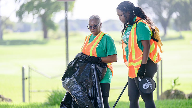Women picking up trash